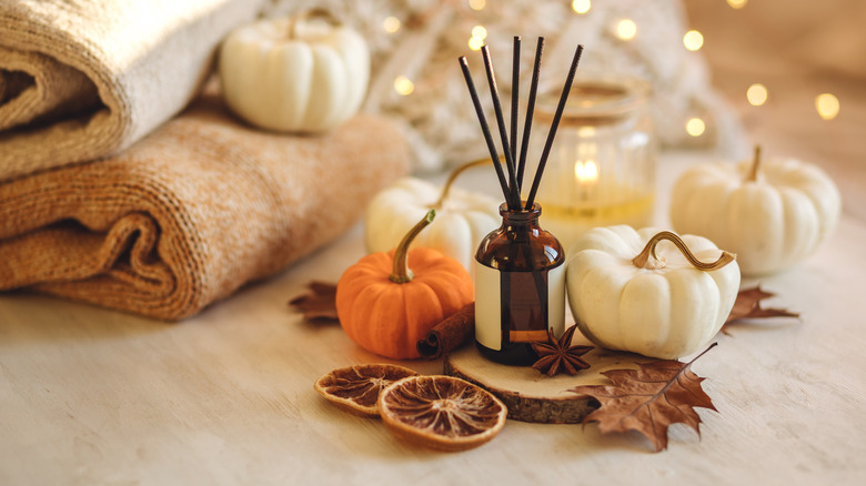 Autumn-themed scent diffuser and pumpkins