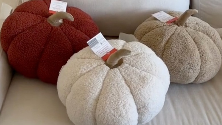 Jumbo pumpkin-shaped pillows on couch