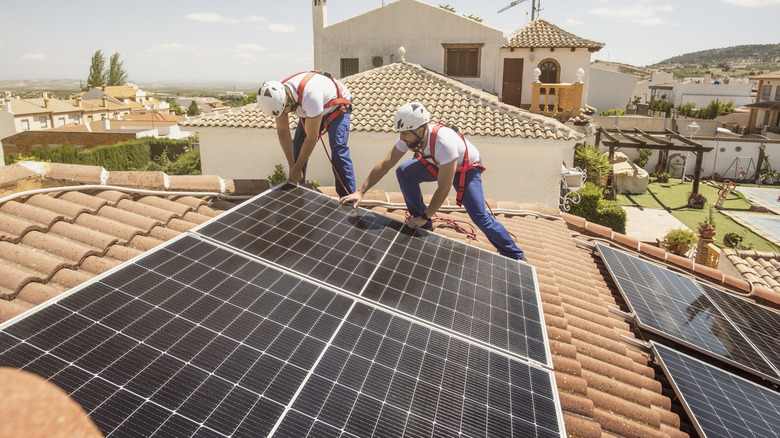Installing solar panels on the roof of a house