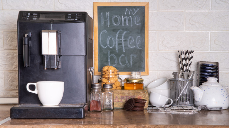 A home coffee station with a cute chalkboard sign on the wall