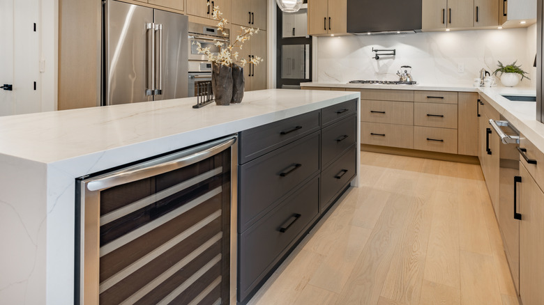 A modern kitchen with large island complete with large, deep drawers