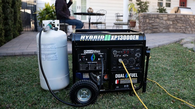 DuroMax 13,000-Watt Dual Fuel Portable Generator with a fuel tank outside