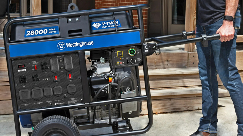 a man pulling a Westinghouse 28,000-Watt Portable Generator