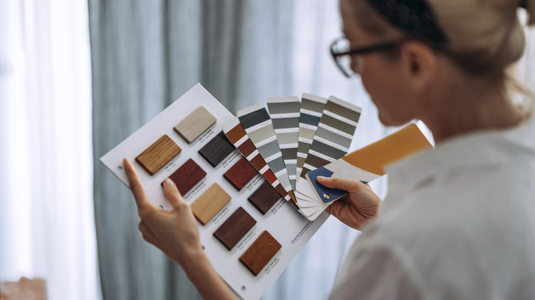 Person picking out paint colors