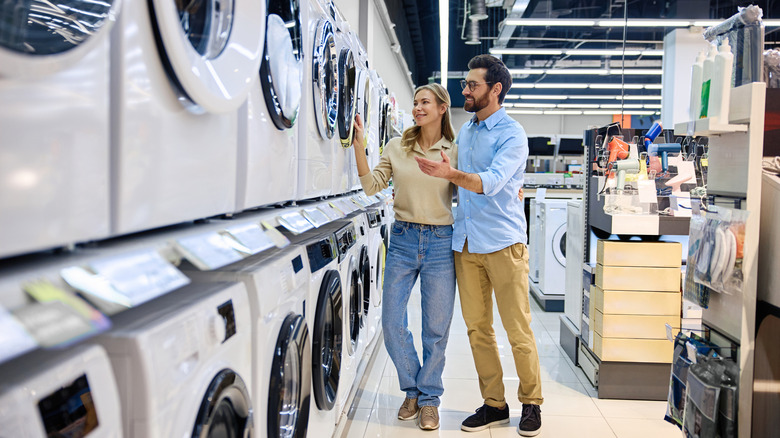 A couple examining appliances in a store