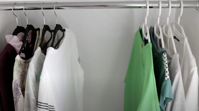 clothes hanging in a wardrobe