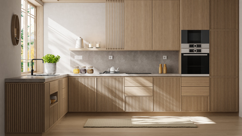 A minimalist home with custom cabinets in fluted wood.