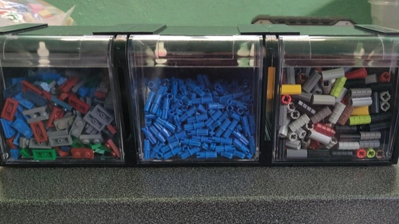 tilt-out bins filled with Lego pieces
