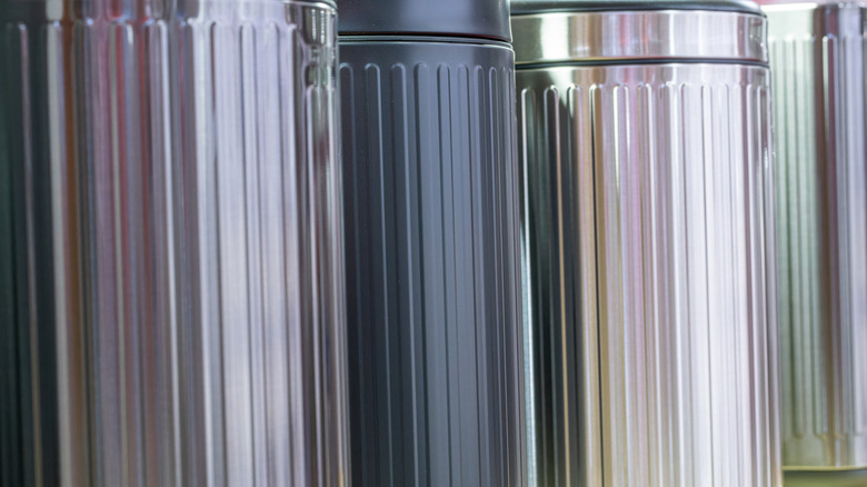 Close-up of metal trash cans in a row at store