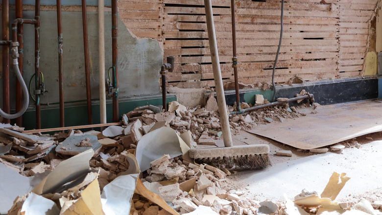 A messy home improvement scene with rubble on the floor