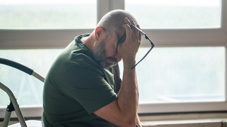A frustrated person sitting in a room mid renovation