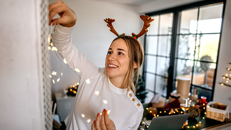 woman hanging Christmas lights