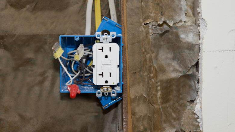 A closeup of a new electrical outlet during a DIY project