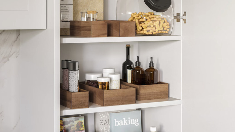 A shot showing cabinet shelves organized with Seville Classics' 9-piece Acacia Organizer Starter Set