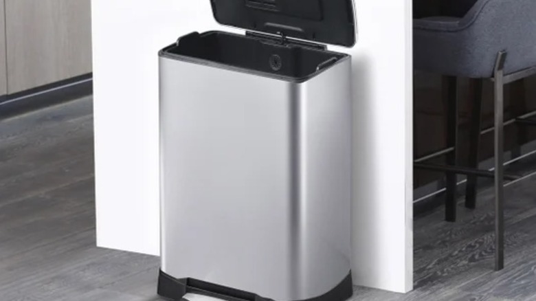 A single compartment stainless steel trash can