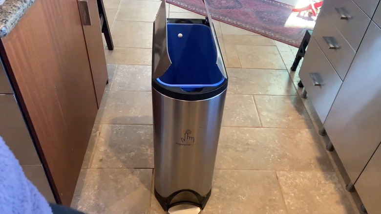 A small trash can with its flaps open on both sides
