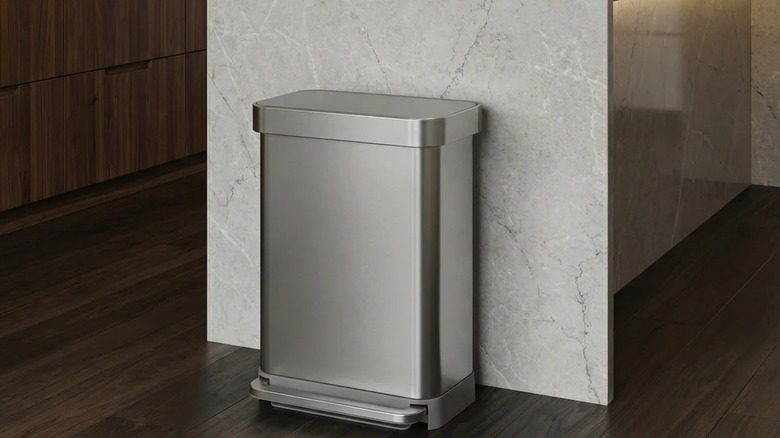 A simple stainless steel trash can in a kitchen