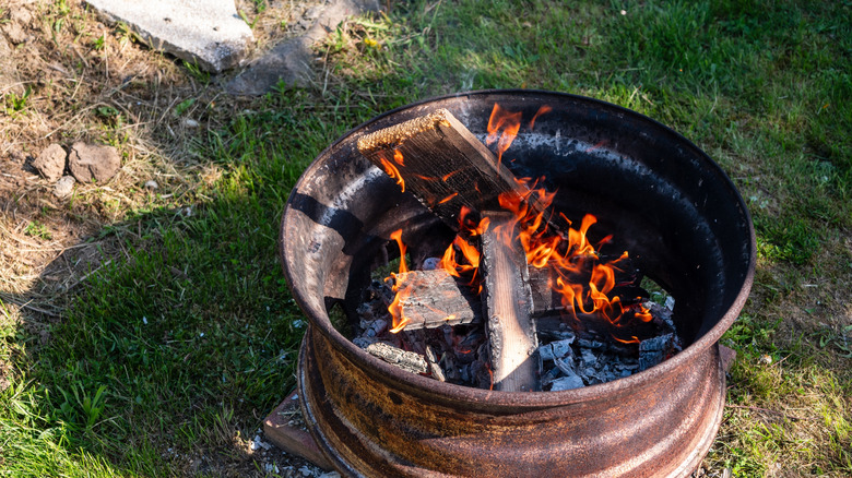 A fire pit made from an old wheel rim.