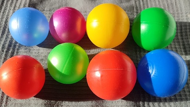 A couple of plastic pit balls on a cloth