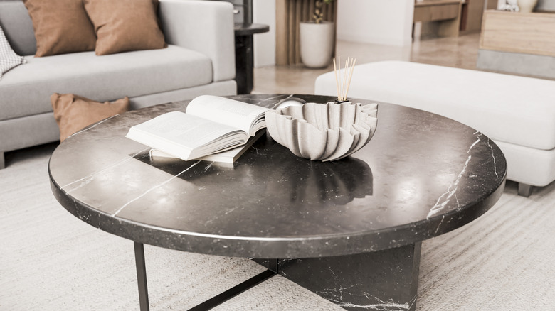 Books open on stone coffee table in living room