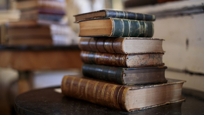 Old vintage stacked books on table