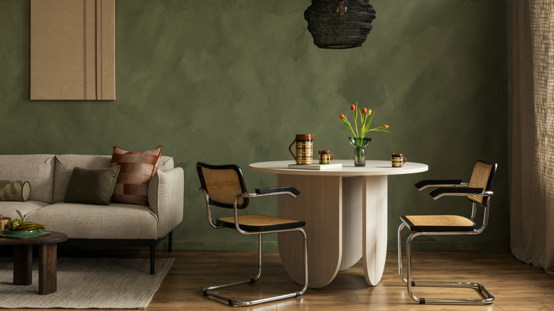 A beautiful dining room with eclectic decor choices and warm-painted walls