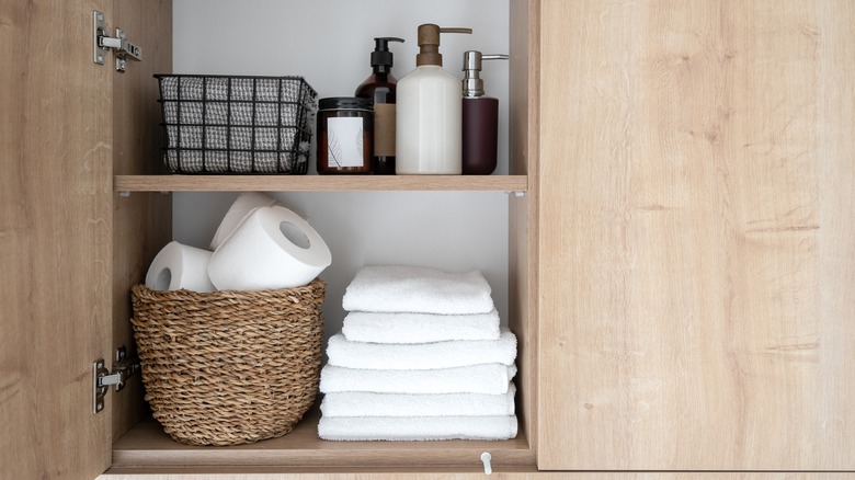 toilet paper and bathroom amenities in wood closet