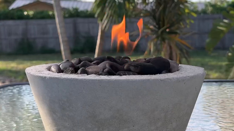 A fire bowl made with a large concrete planter