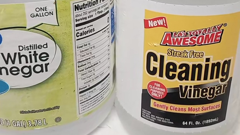 A bottle of Dollar Tree's cleaning vinegar next to a different off brand.