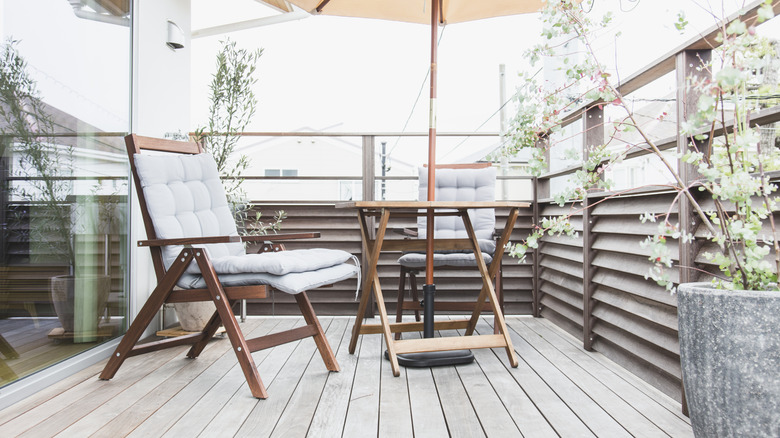 A deck designed with folding chairs and a folding table