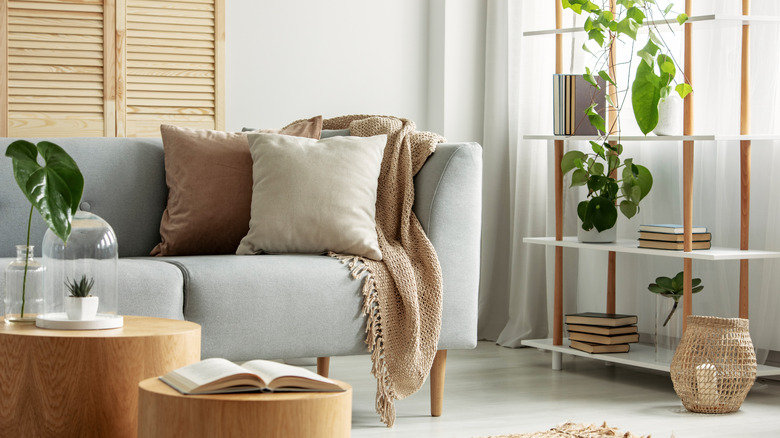 A modern living room with a set of freestanding shelves in the background