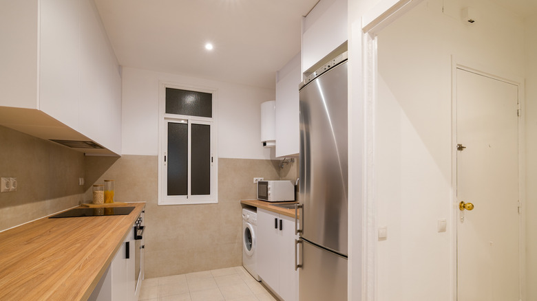 Galley kitchen with tall upper cabinetry