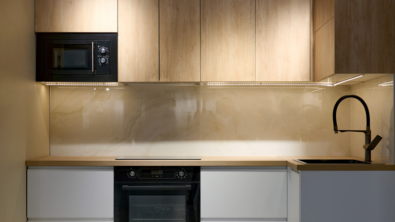 Small modern kitchen with empty countertops beside appliances