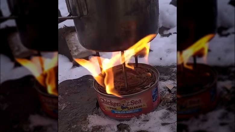 A tuna can filled with a cardboard coil and alcohol become a mini stove.