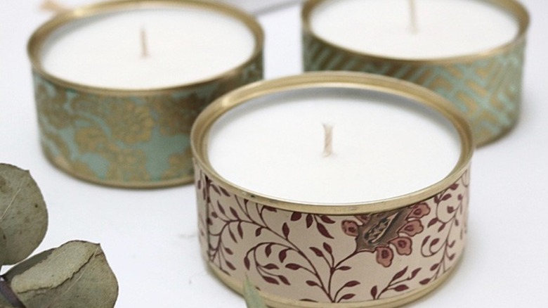 Upcycled fish cans hold candles.