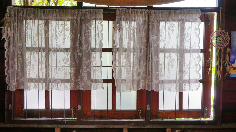 A window with lace curtains