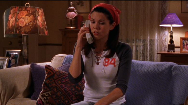 Woman sitting on a couch talking on a phone