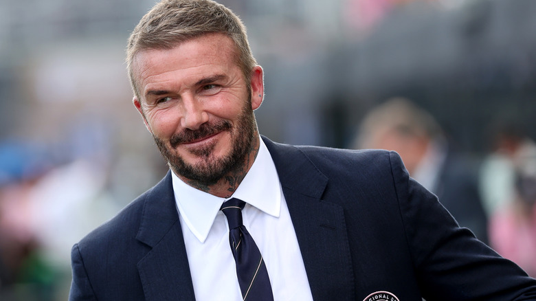 David Beckham wearing a suit at a game