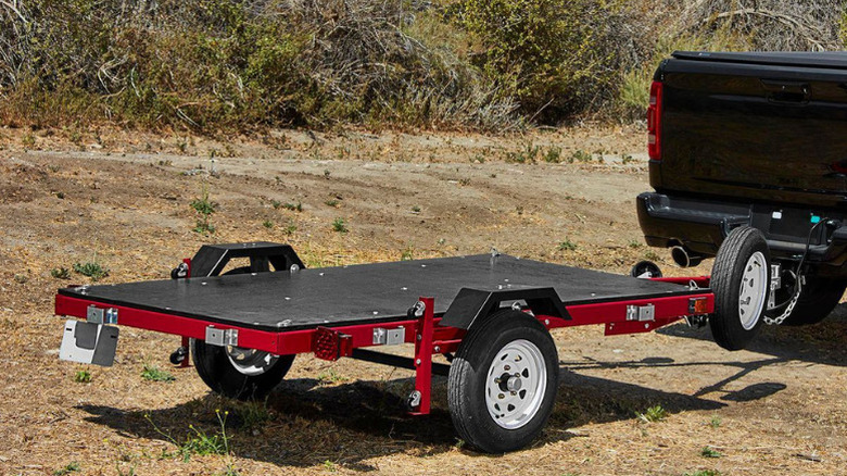 A truck towing Haulmaster's 1,720-pound Heavy Duty Folding Trailer