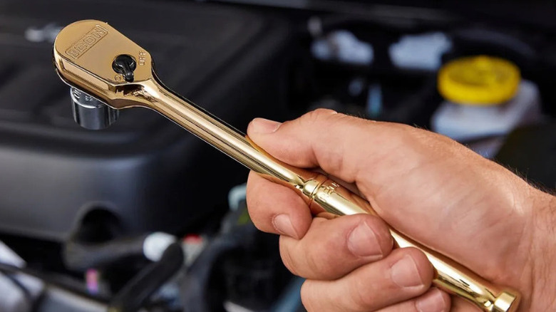 Close-up of a hand holding Icon's 24-Carat Gold Plated Ratchet