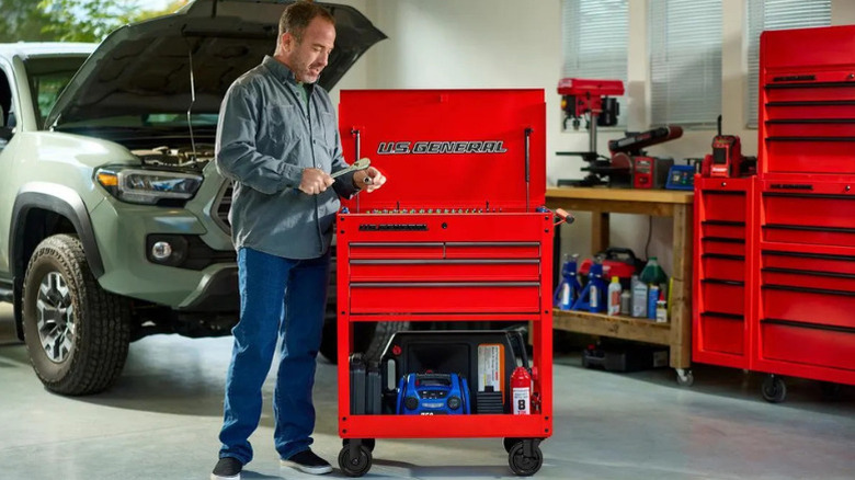 A man using U.S. General's 30 in, 4-Drawer Tech Cart