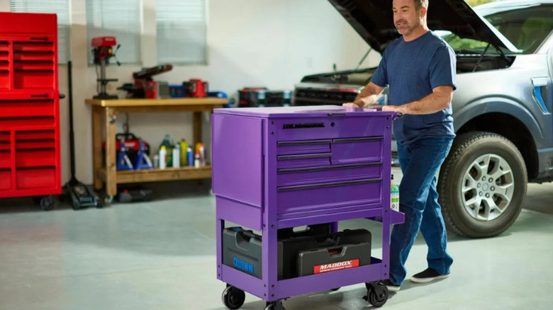 A man using U.S. General's 30 in., 5-Drawer Mechanics Cart