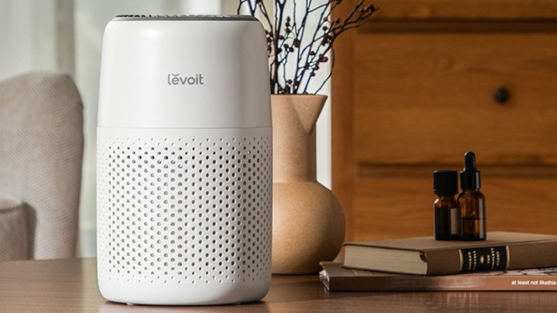 Levoit's white air purifier on a wood table in a room