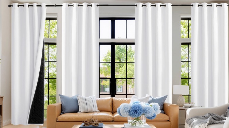 White black out curtains hanging from a living room window