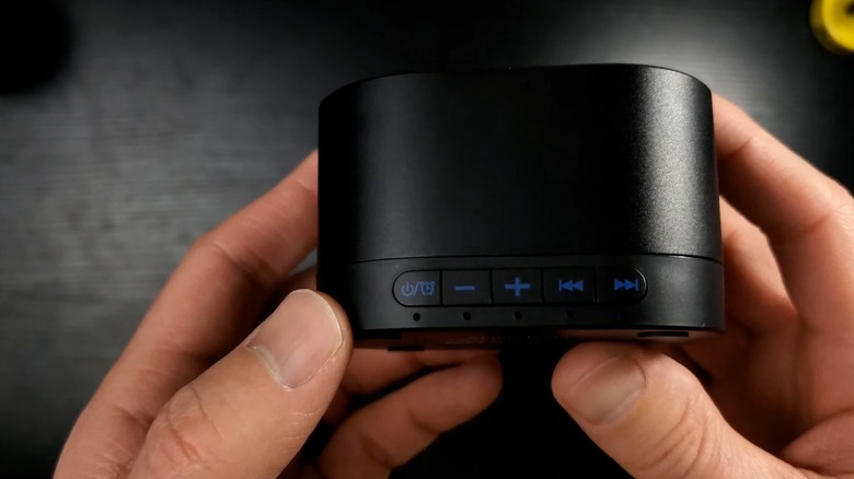 Hands holding a black white noise machine