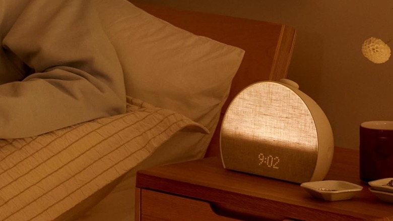 A dimmed alarm clock on a beside table