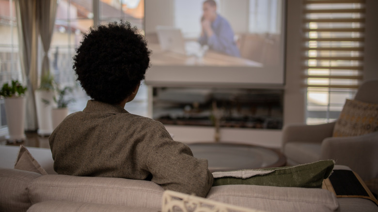 Woman watching TV in home theater