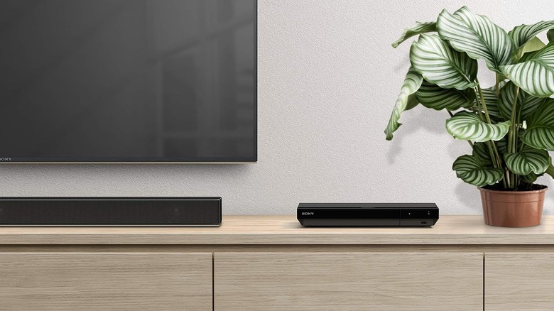 The Sony UBP-X700U 4K Ultra HD Home Theater Blu-Ray DVD Player on a TV stand
