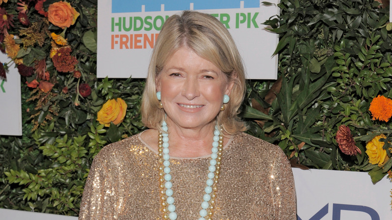 Martha Stewart smiling at the camera in a gold sparkly top