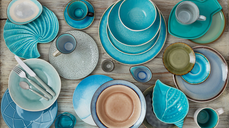 A variety of different but complementary plates on a wood table